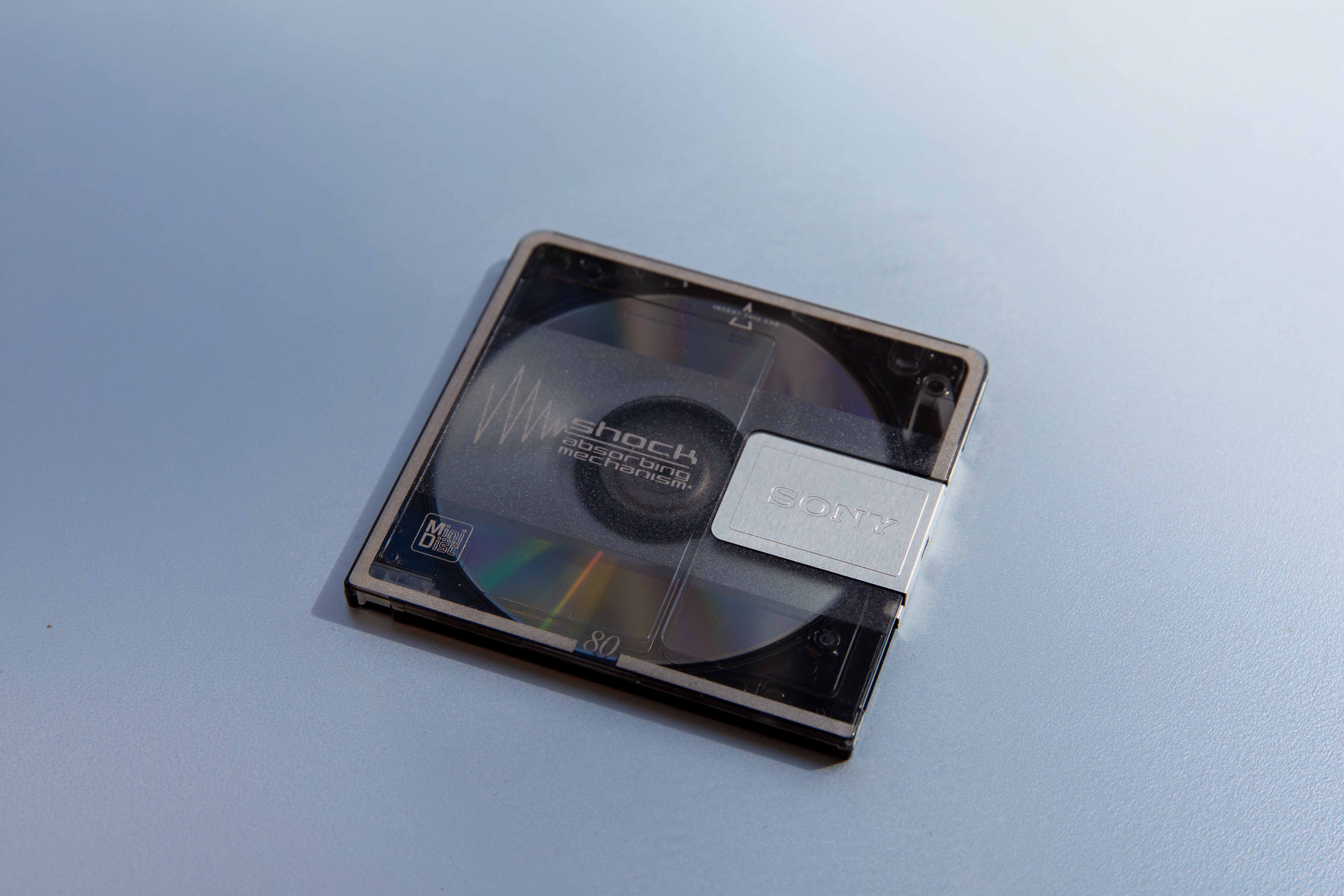 Sony MiniDisc photographed on a pale blue surface
