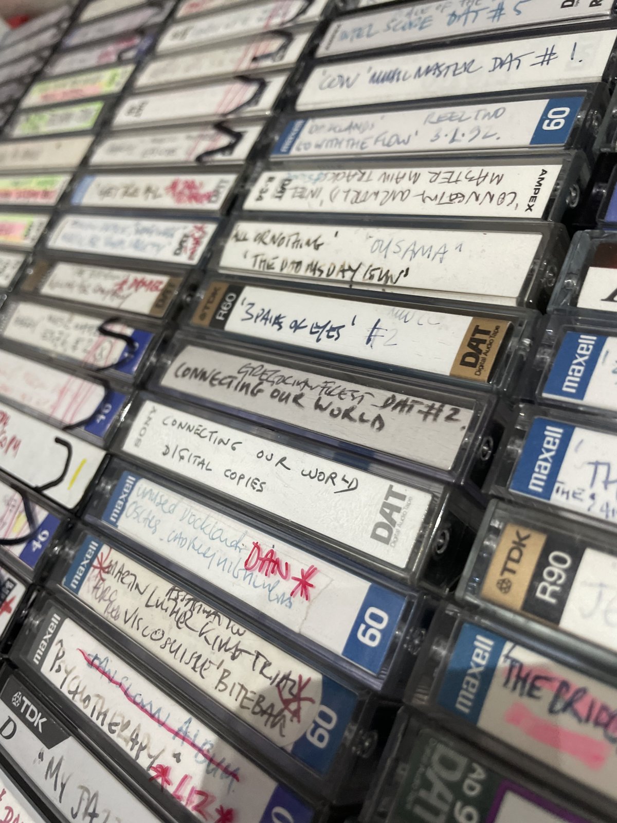 An archive collection of DAT recordings with original handwritten labels